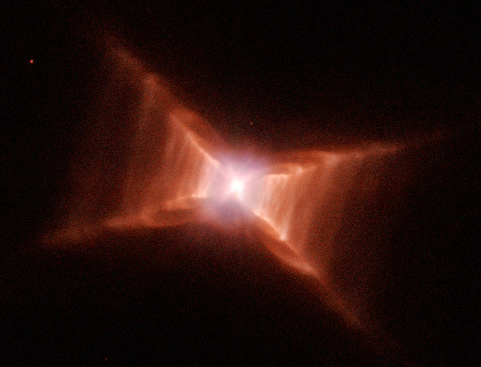 Hubble observation of the Red Rectangle: a bright center surrounded by reddish X-shaped gas and dust, with parallel rungs resembling a ladder.